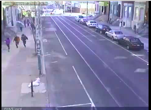 Manning, teammates running down Girard - the PPD van can be seen in the intersection in the distance